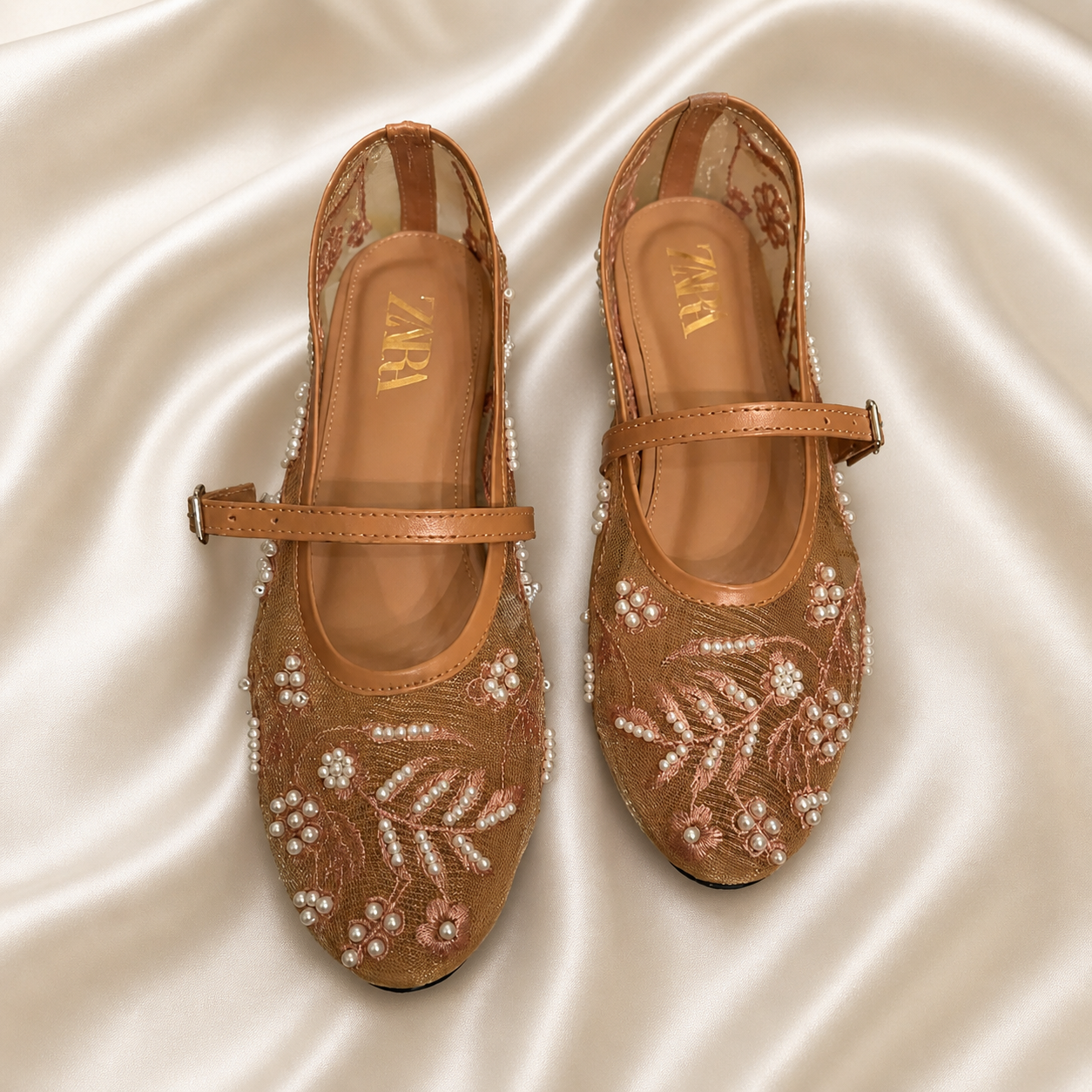 Beige embroidered Finsha Shoes black mules with intricate embroidery and slip-on design for stylish comfort.