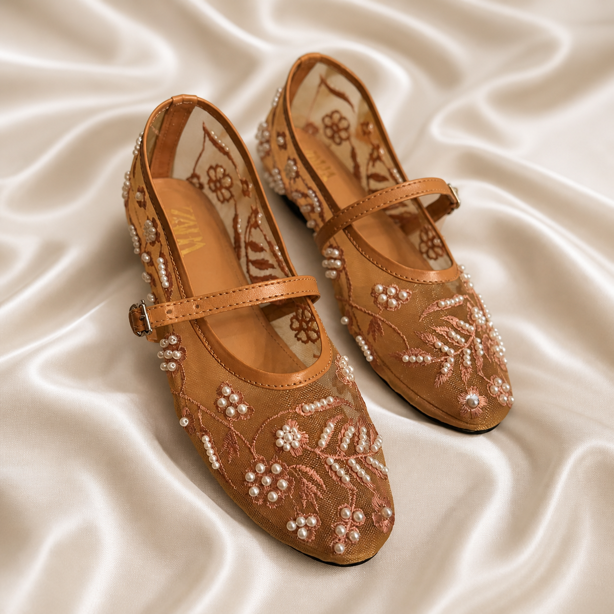 Beige embroidered black mules from Finsha Shoes featuring intricate embroidery and slip-on style.