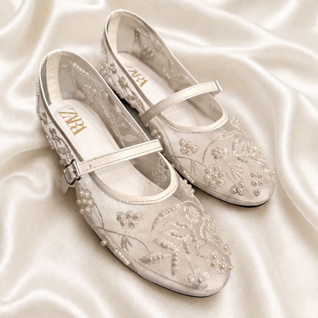 White embroidered Finsha Shoes black mules featuring intricate embroidery and a stylish, comfortable slip-on design.
