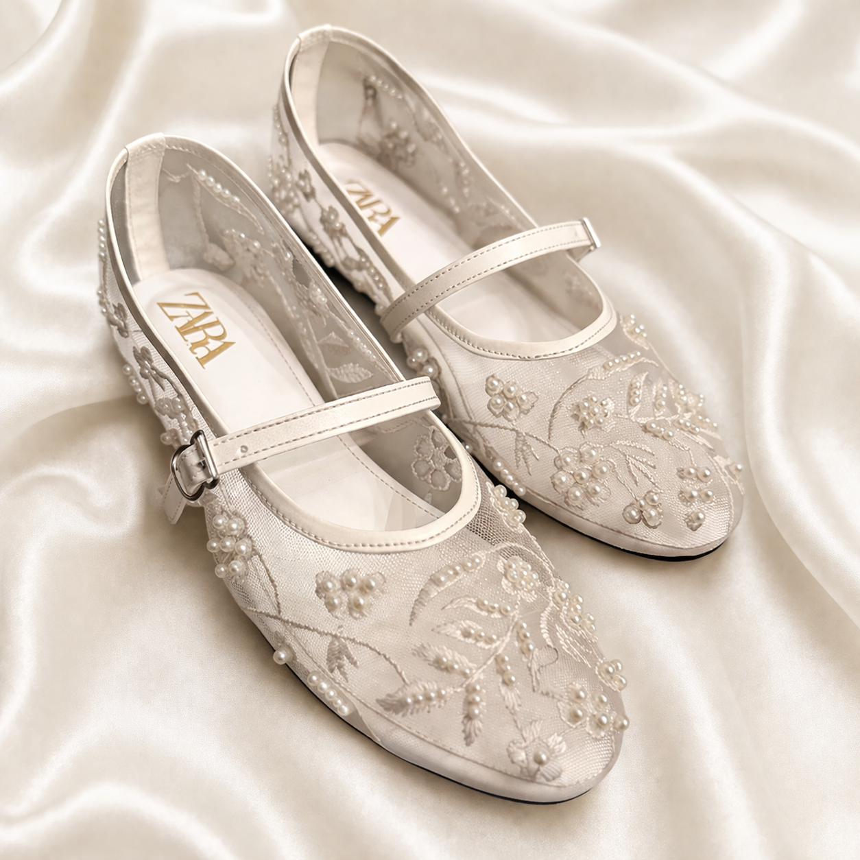 White embroidered Finsha Shoes black mules featuring intricate embroidery and a stylish, comfortable slip-on design.