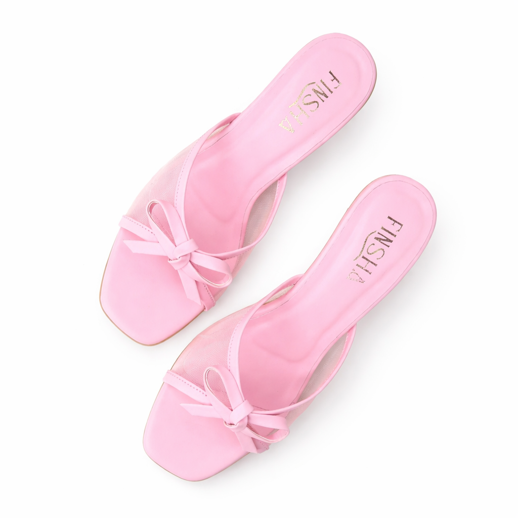 Baby pink sandal from Finsha Shoes with a soft strap and small bow detail, perfect for little feet.