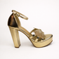 Gold LYNIX 5-inch platform heel from Finsha Shoes featuring a stylish, high-rise design with a chunky heel and glossy finish.